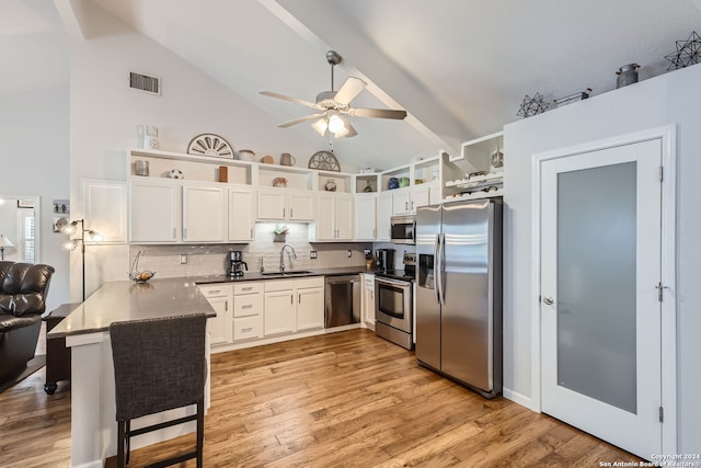 kitchen featuring kitchen peninsula, sink, white cabinetry, appliances with stainless steel finishes, and ceiling fan