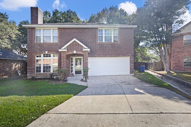 view of front property with a front yard and a garage