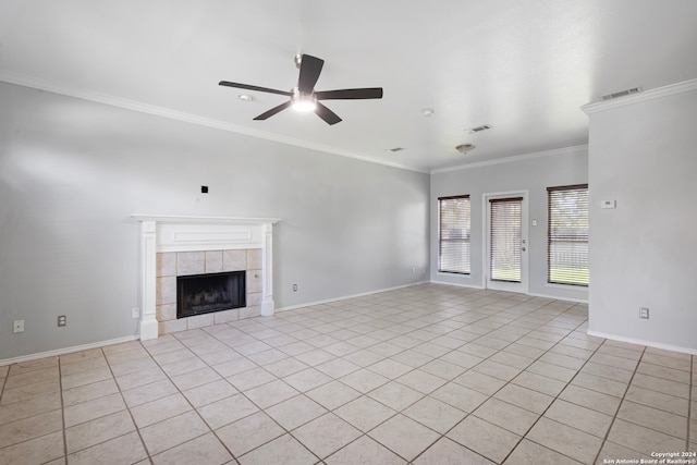 unfurnished living room with ornamental molding, light tile patterned flooring, a fireplace, and ceiling fan