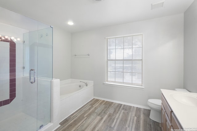 full bathroom with vanity, toilet, hardwood / wood-style flooring, and independent shower and bath