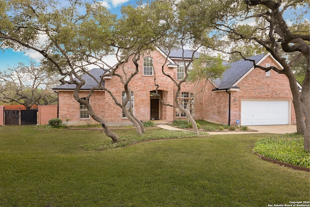 view of front of home featuring a garage and a front lawn