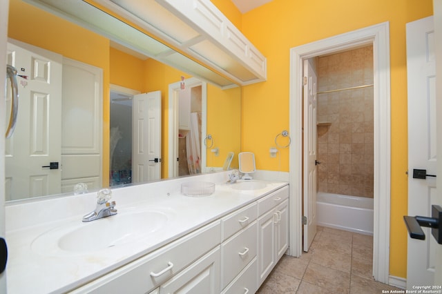 bathroom with shower / bath combo with shower curtain, tile patterned flooring, and vanity