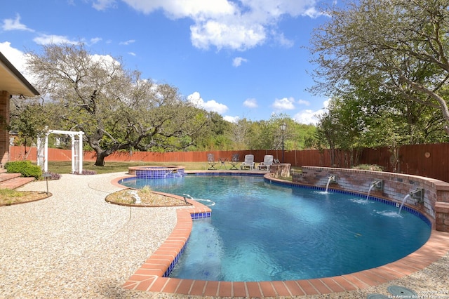 view of pool featuring a fenced backyard, a patio, and a pool with connected hot tub