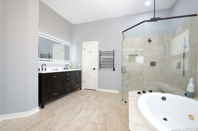 full bath featuring a shower stall, a garden tub, double vanity, and baseboards
