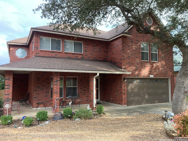 front of property with covered porch and a garage