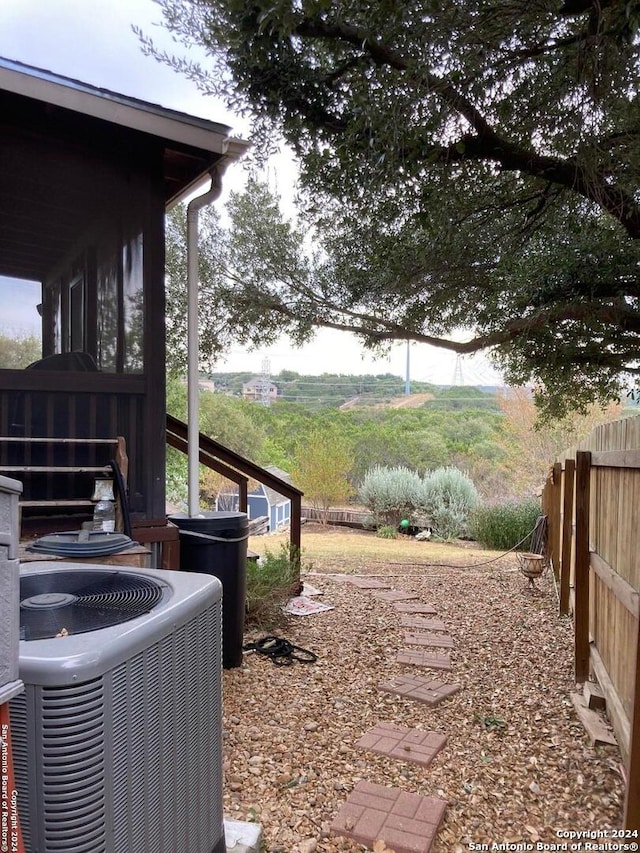 view of yard with a rural view and central air condition unit