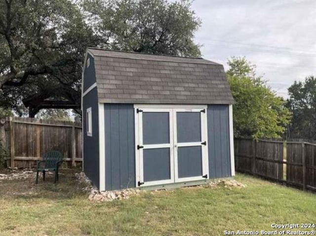 view of outdoor structure featuring a lawn