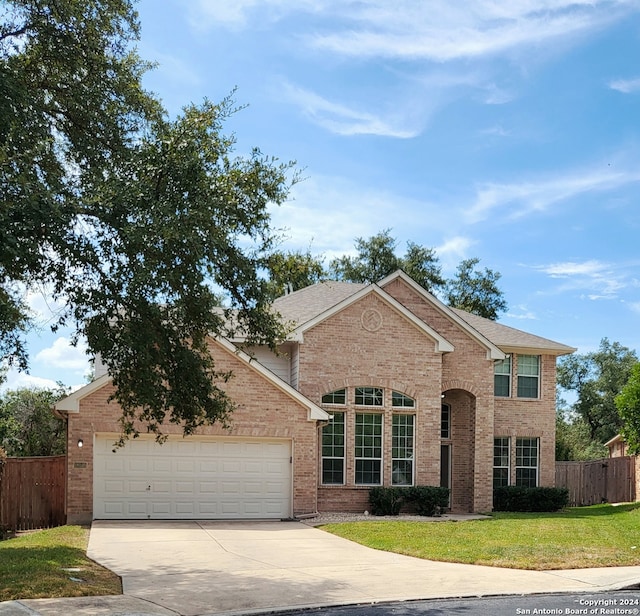 view of front of property with a front yard and a garage