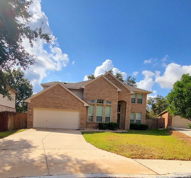 view of front facade with a front yard and a garage