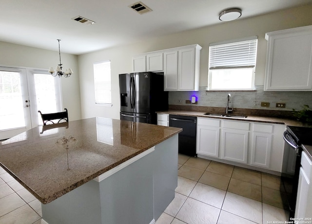 kitchen featuring white cabinetry, black appliances, sink, and a kitchen island