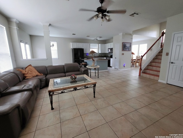 tiled living room featuring ceiling fan and a wealth of natural light