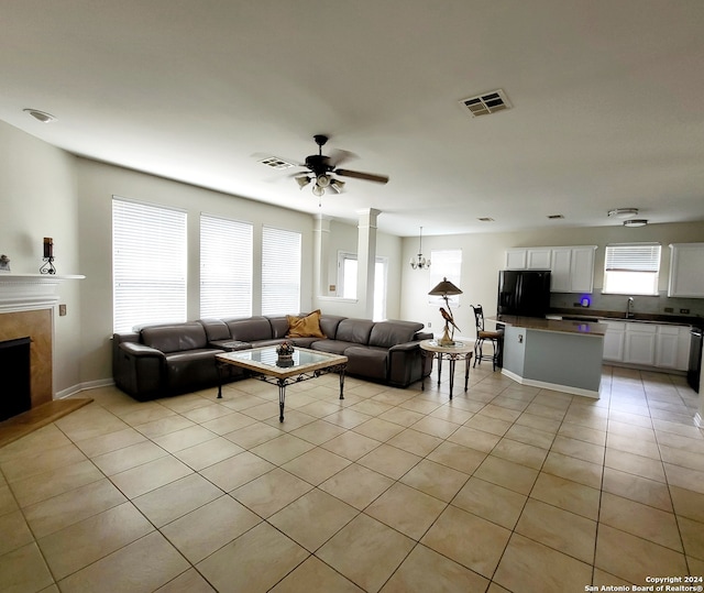 living room with light tile patterned flooring, sink, and ceiling fan