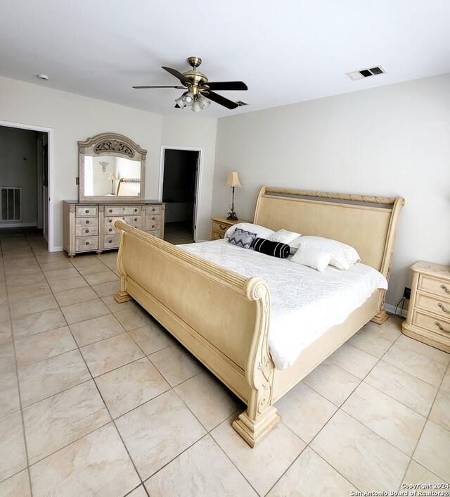 tiled bedroom featuring ceiling fan