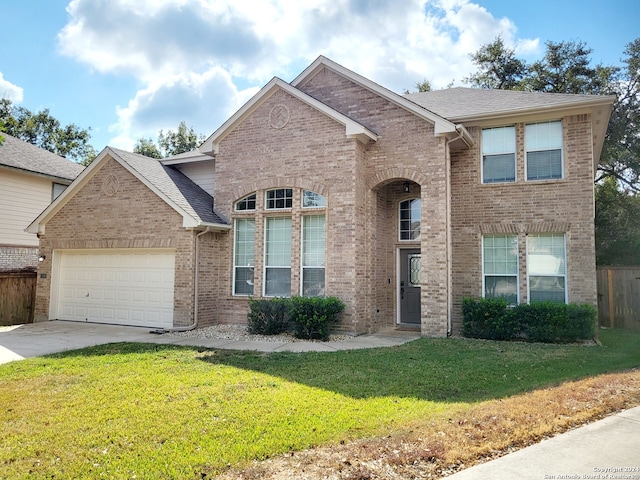 view of front of home with a front yard and a garage