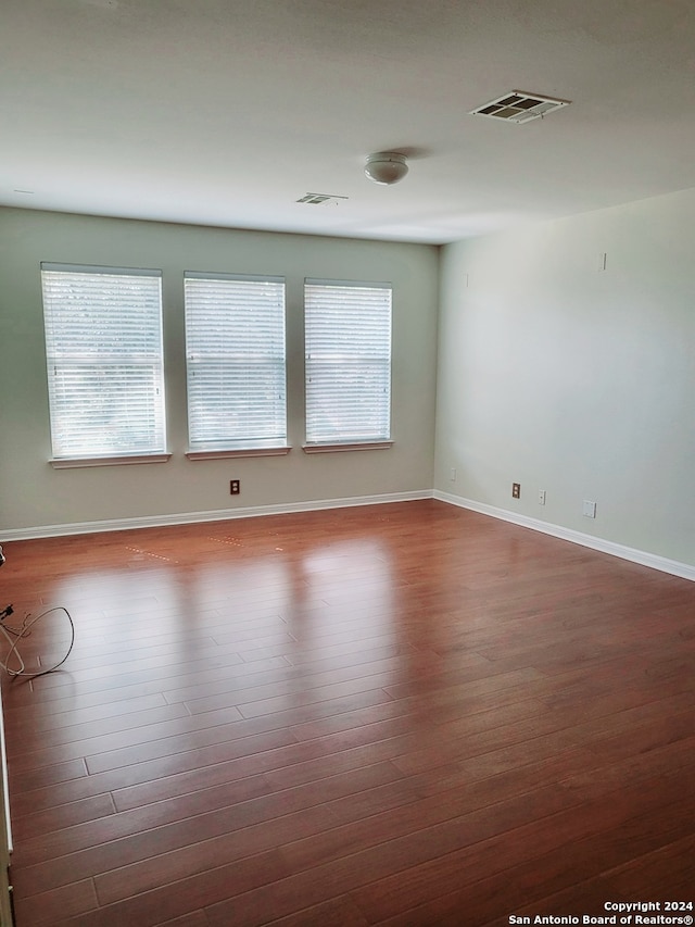 spare room with dark hardwood / wood-style flooring