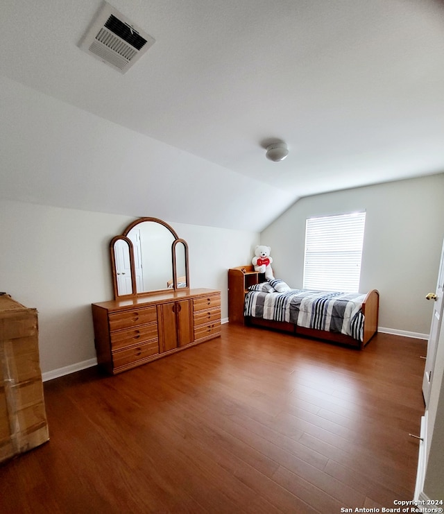 bedroom featuring lofted ceiling and dark wood-type flooring