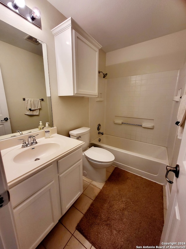 full bathroom with vanity, tiled shower / bath combo, toilet, and tile patterned floors