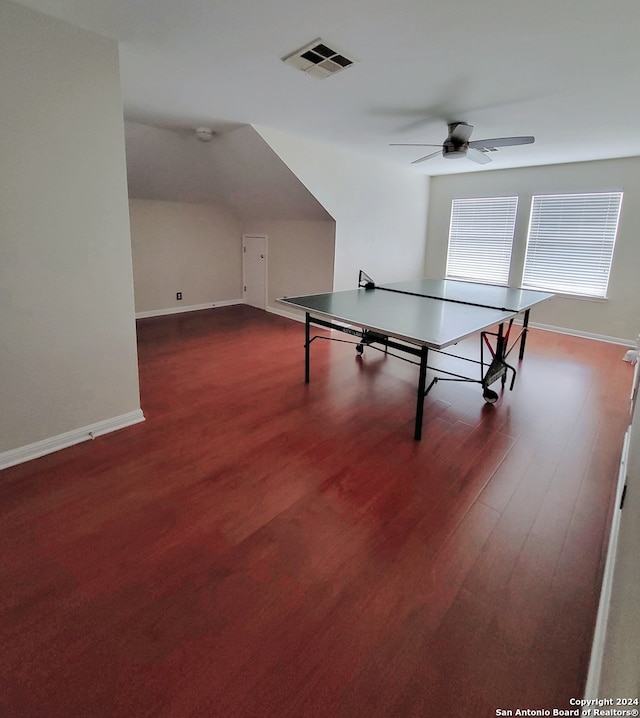 game room featuring ceiling fan, lofted ceiling, and dark hardwood / wood-style flooring