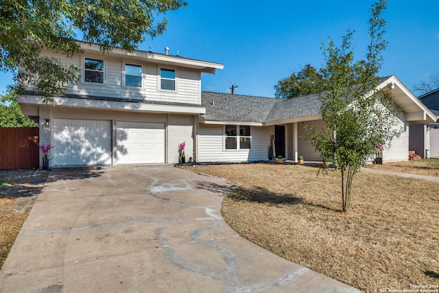 front facade featuring a garage and a front lawn