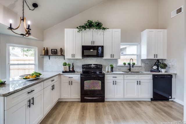 kitchen with white cabinetry, lofted ceiling, sink, backsplash, and black appliances