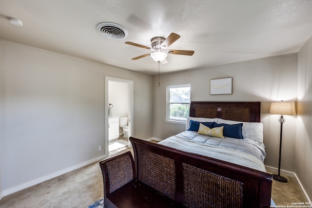 bedroom featuring ensuite bathroom, carpet, and ceiling fan