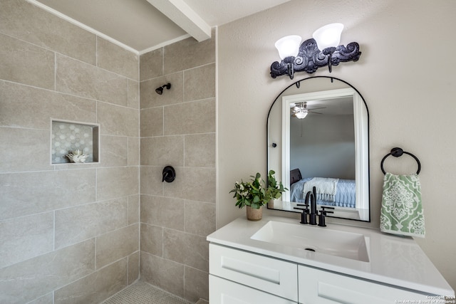 bathroom featuring vanity and a tile shower