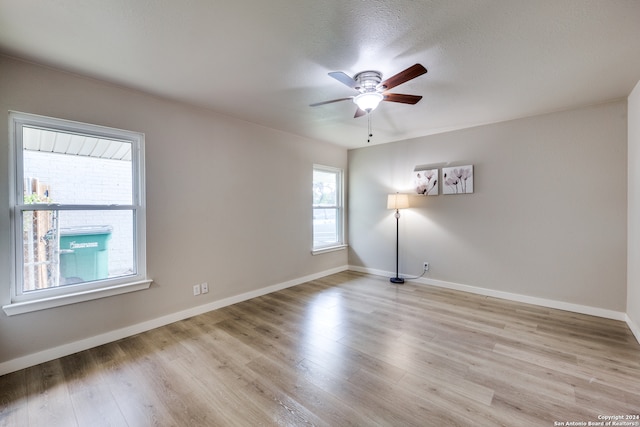 empty room featuring ceiling fan and light hardwood / wood-style flooring