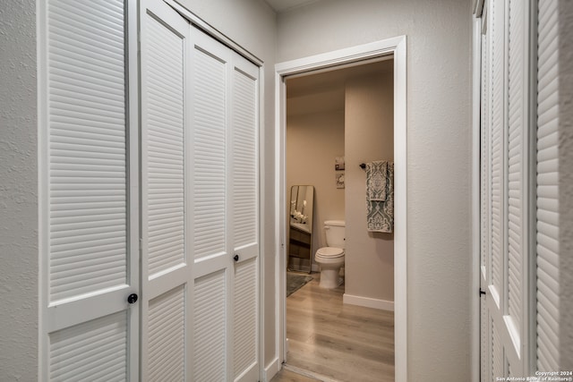 bathroom featuring wood-type flooring and toilet