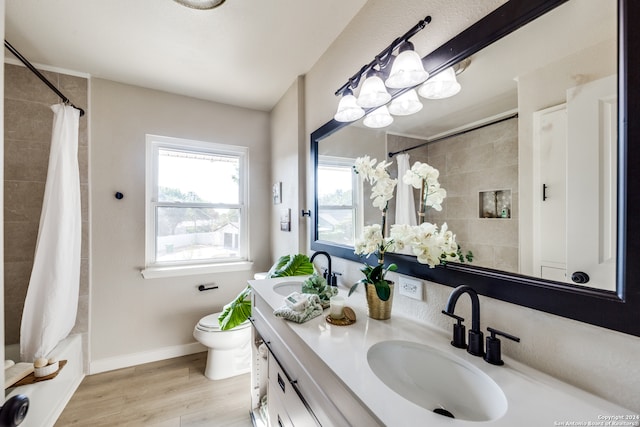 full bathroom with vanity, hardwood / wood-style floors, shower / tub combo, and toilet