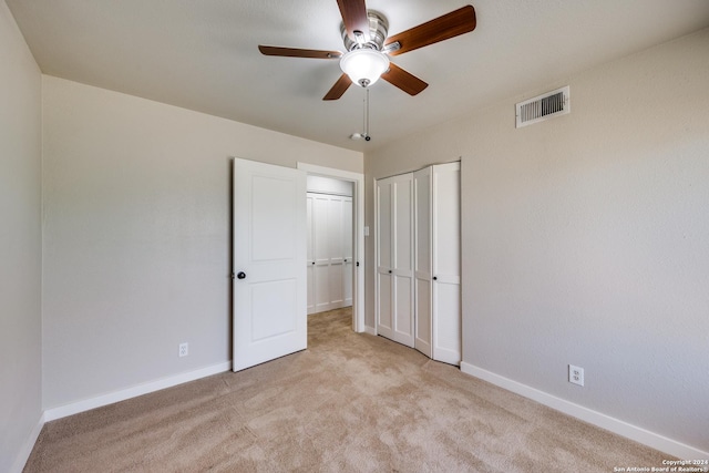 unfurnished bedroom featuring light carpet and ceiling fan