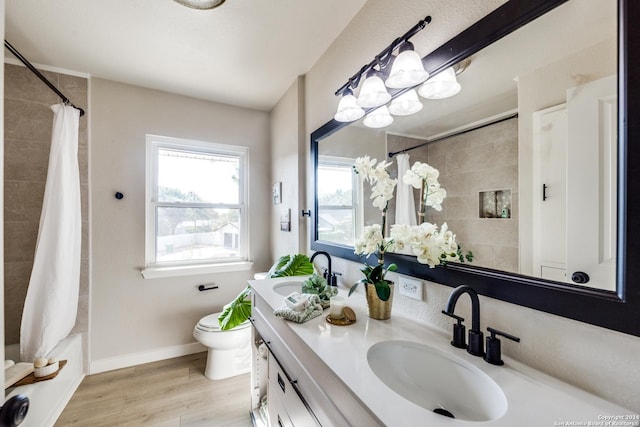 full bathroom with vanity, hardwood / wood-style floors, shower / bathtub combination with curtain, and toilet