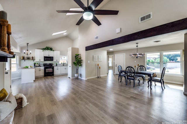 interior space with high vaulted ceiling, wood-type flooring, a chandelier, and sink