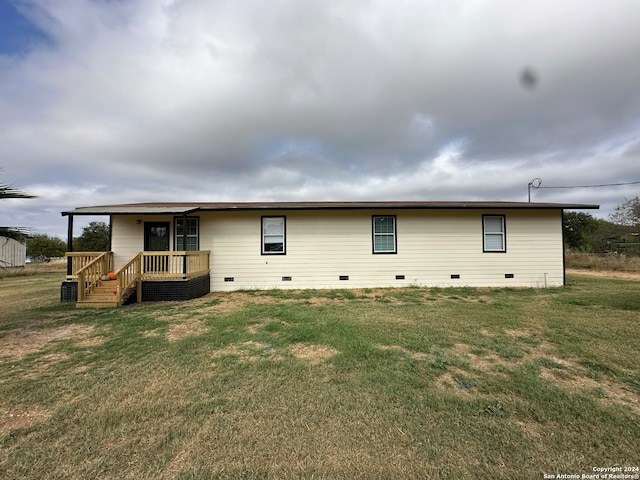 rear view of house featuring a yard