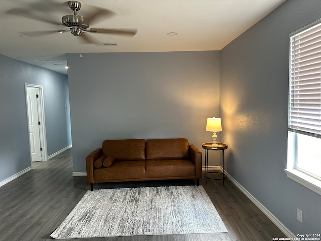 living room featuring dark hardwood / wood-style floors and ceiling fan