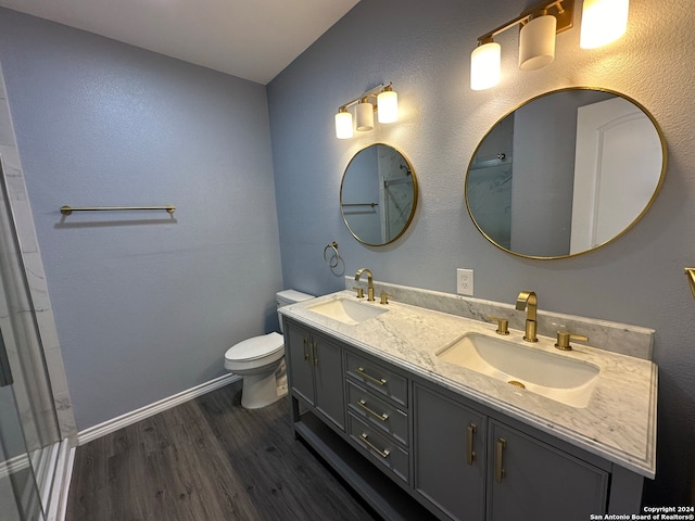 bathroom with toilet, hardwood / wood-style floors, and vanity