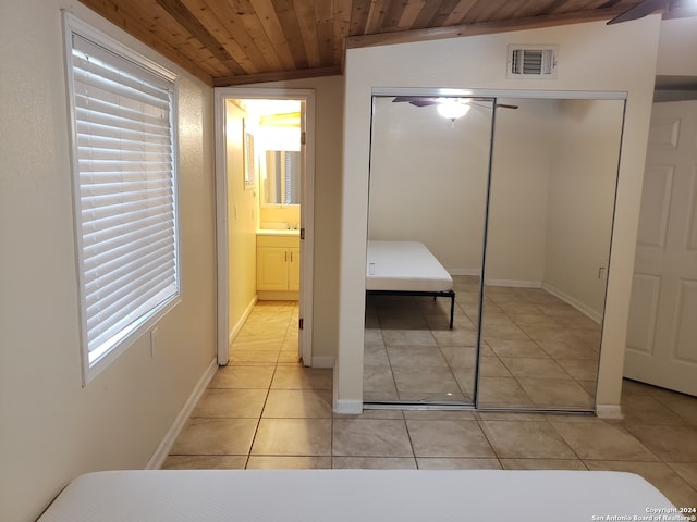 bedroom with ceiling fan, light tile patterned flooring, wooden ceiling, and lofted ceiling