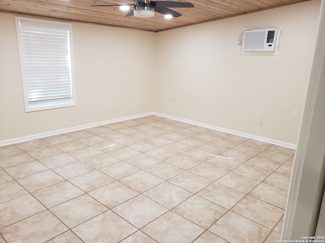 tiled empty room with wood ceiling, a wall unit AC, and ceiling fan