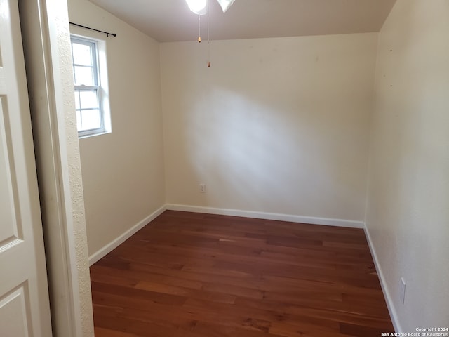 empty room with lofted ceiling, dark wood-type flooring, and ceiling fan