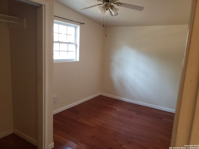 spare room with lofted ceiling, dark hardwood / wood-style floors, and ceiling fan