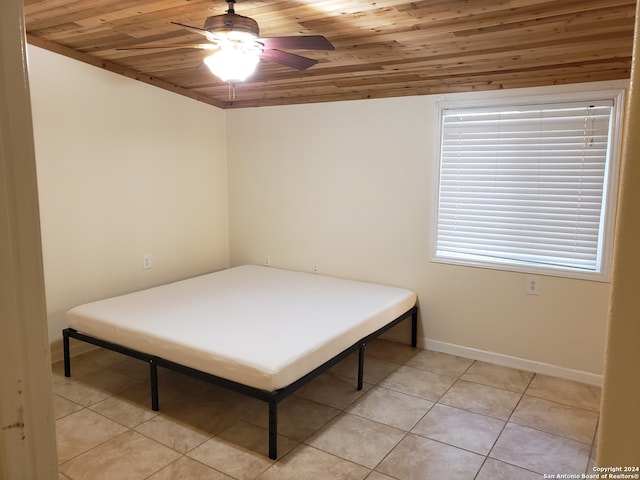 tiled bedroom with wooden ceiling and ceiling fan