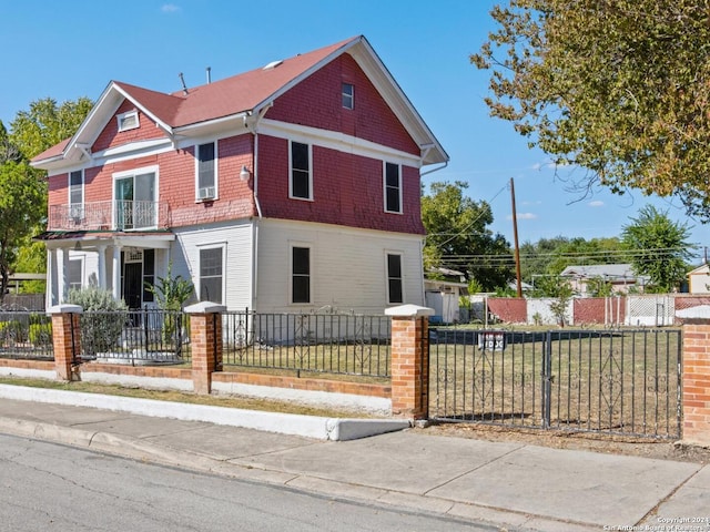 view of front of property featuring covered porch and a balcony