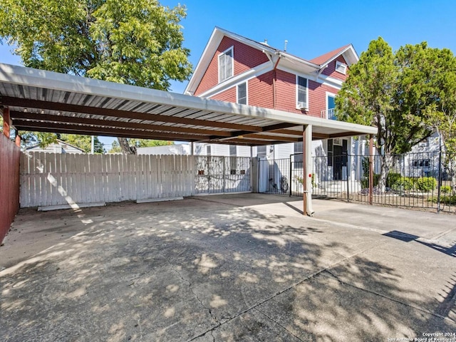 view of parking / parking lot featuring a carport