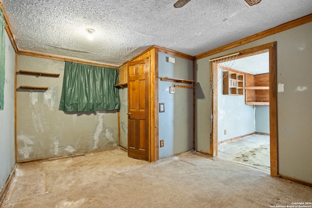 interior space featuring ornamental molding and a textured ceiling