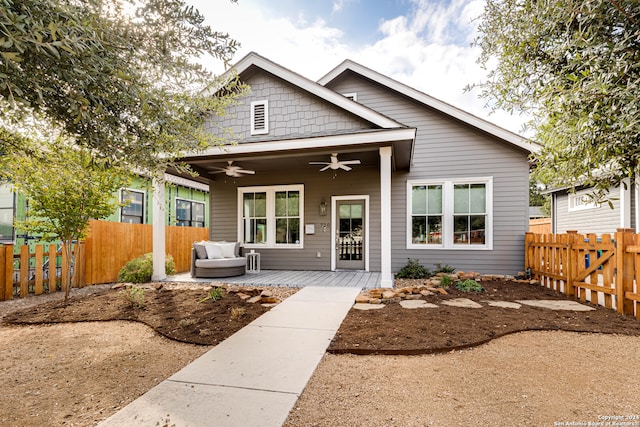 bungalow-style home with ceiling fan and an outdoor hangout area