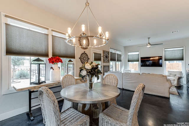 dining space featuring ceiling fan with notable chandelier