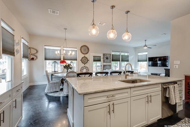 kitchen with dishwasher, light stone countertops, sink, and plenty of natural light