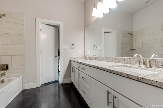 bathroom featuring vanity, tiled shower / bath, and concrete flooring