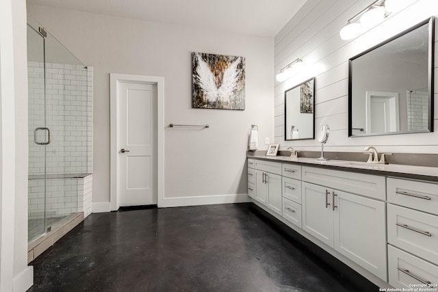 bathroom with vanity, concrete floors, and a shower with shower door