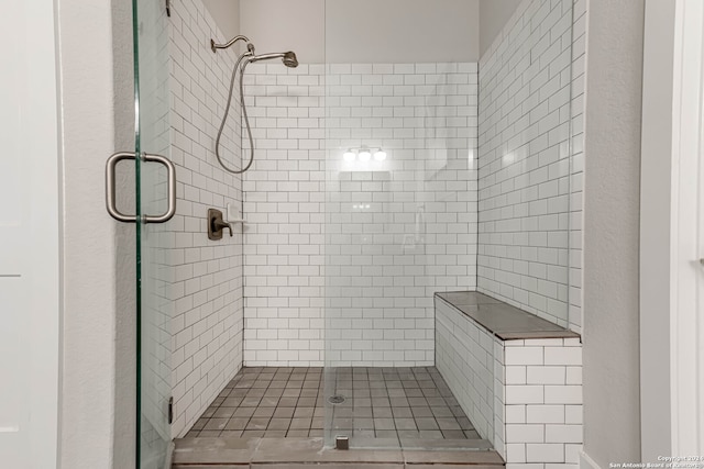 bathroom featuring a shower with door