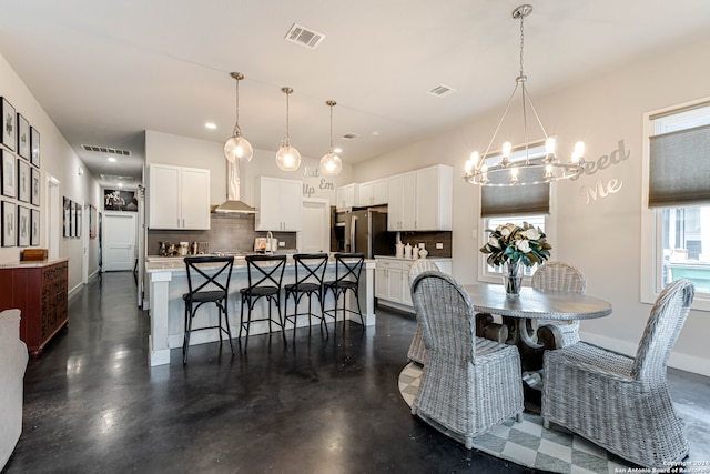 dining space featuring an inviting chandelier